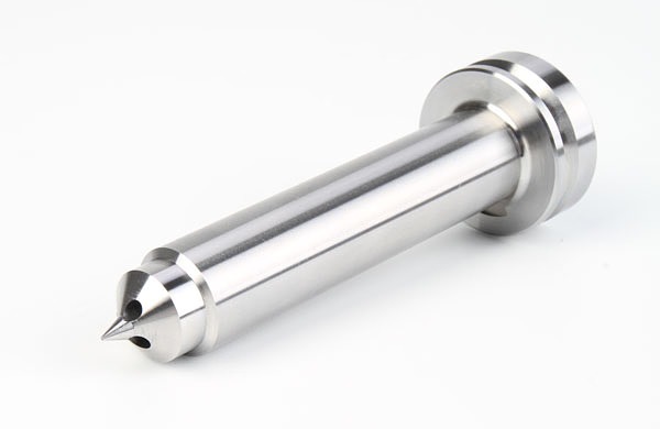 Close-up of a precision-machined carbide punch with a sharp tip and polished finish